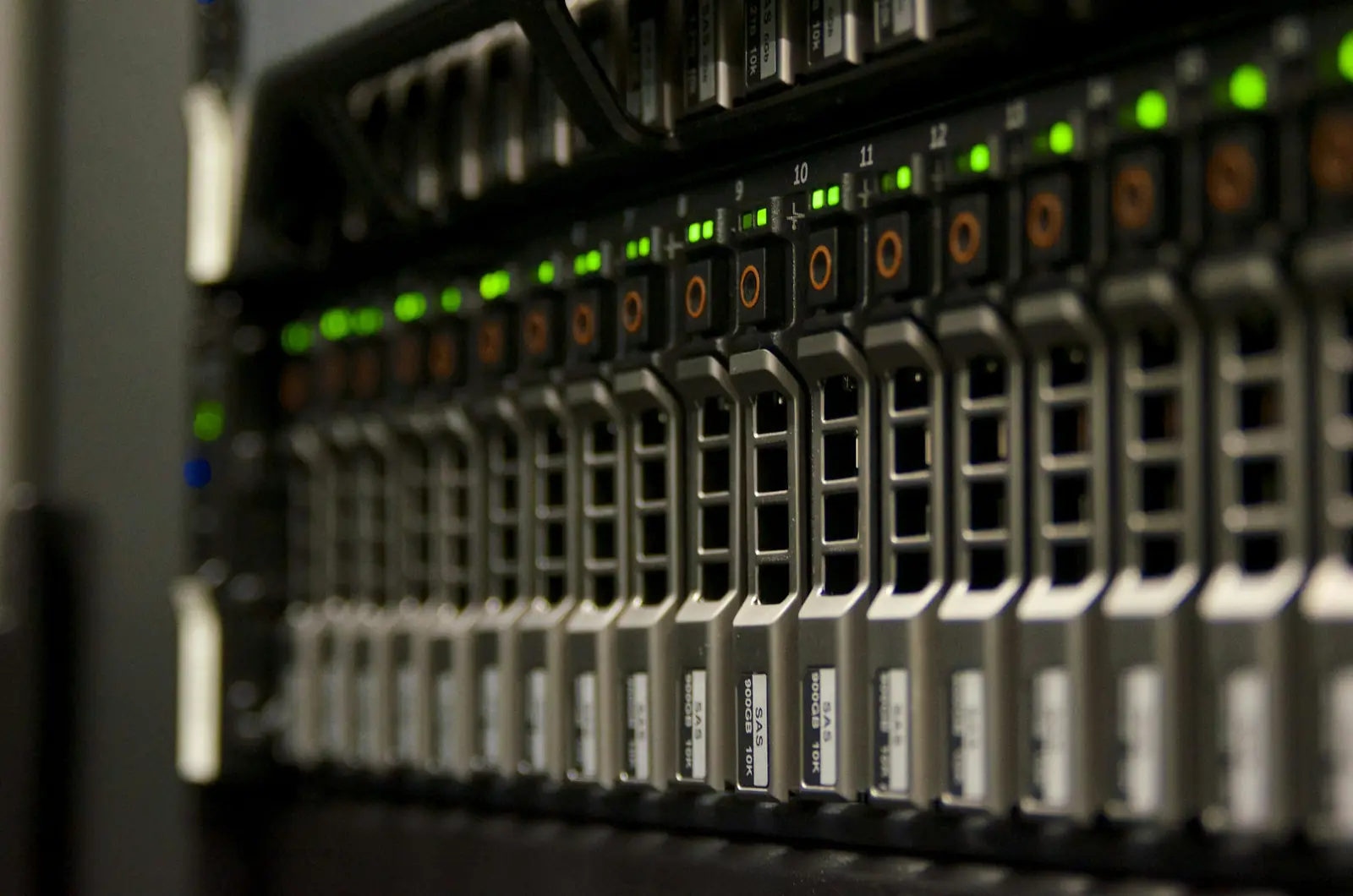 A row of server drive bays with green and amber status lights